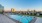 Dog-Friendly Apartments in Downtown San Diego, CA - Radian - Pool with City View, Sun Lounge Chairs, and Hot Tub