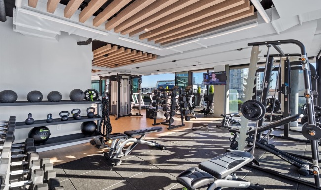 Amenities that Inspire fitness center with ample equipment and modern decor